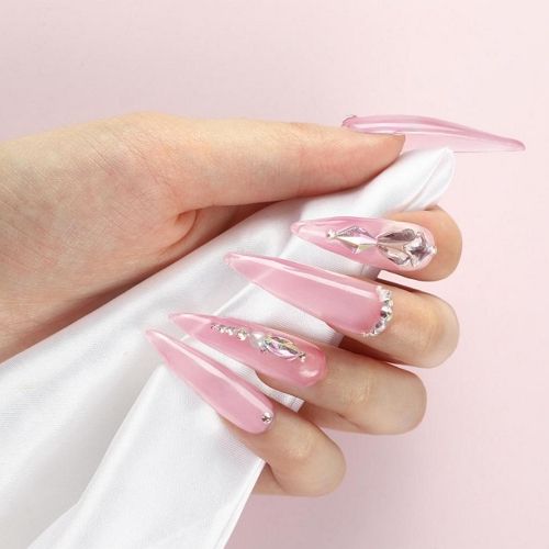 translucent pink clear pink nails with rhinestones and sharp tips