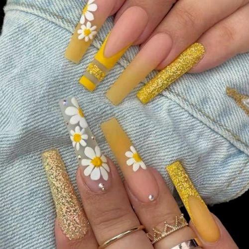 long coffin nails with yellow french tips, glitter and daisy flowers