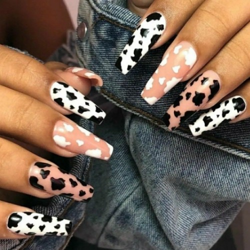 nails with cow spots on white and nude pink background