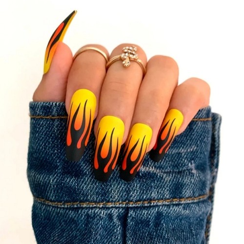 yellow and orange ombre coffin nails with black flame