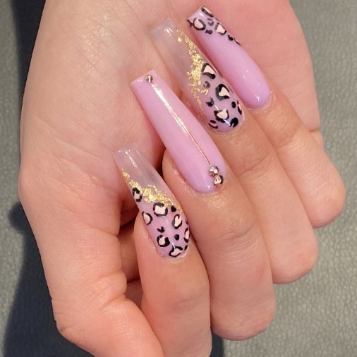 acrylic long pink leopard print coffin nails with rhinestones and gold foil accents