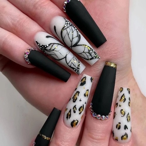 acrylic matte black coffin nails with gold design elements and nail art