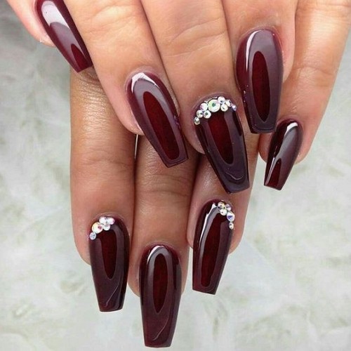 glossy coffin burgundy nails with rhinestones on some nails