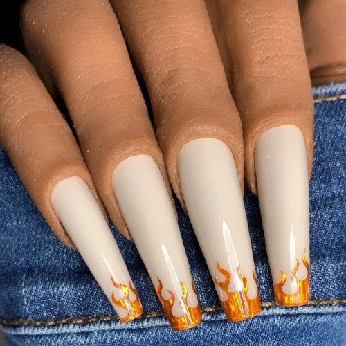 long white press-on coffin nails with gold flames on top
