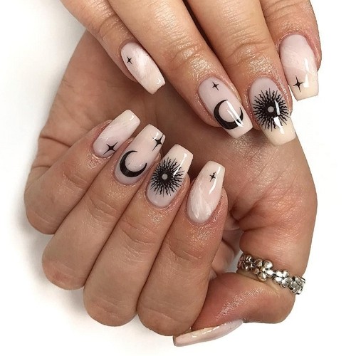 medium coffin moon nails with black nail art elements (stars, sun, moon)