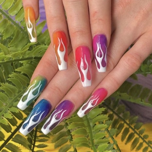 multi-colored long acrylic rainbow nails with white flames
