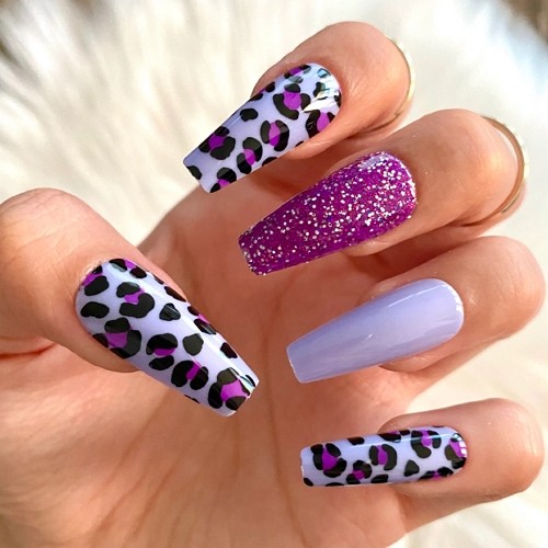 press-on pink leopard print coffin nails on purple backround with glitter accents