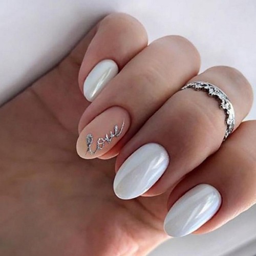 white and nude beige uv-gel round coffin nails with a silver sticker