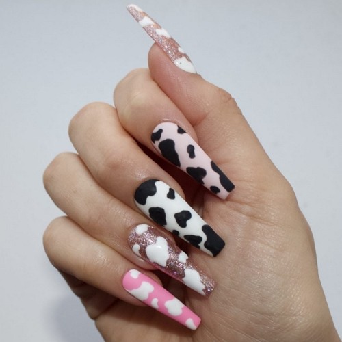 long cow coffin nails with bright pink and glitter design