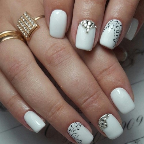 medium square white nails with shellac coverage and minimalistic flower and rhinestone design