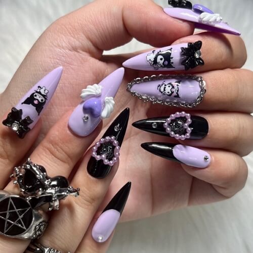 Purple and black stiletto nails with swarowski elements, pearls and wings in gothic style