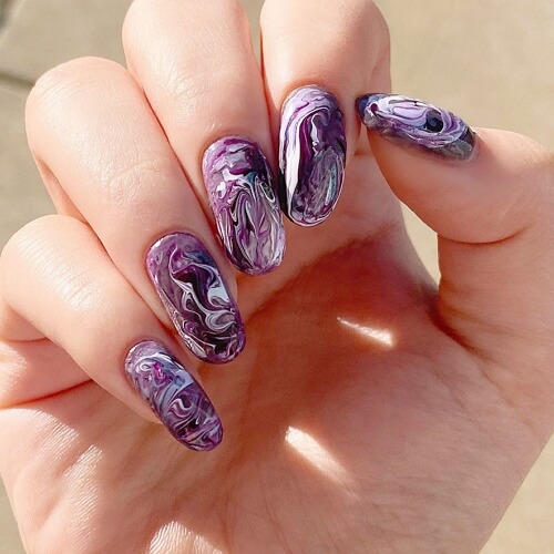 Round edged purple, white and black water marble nail design